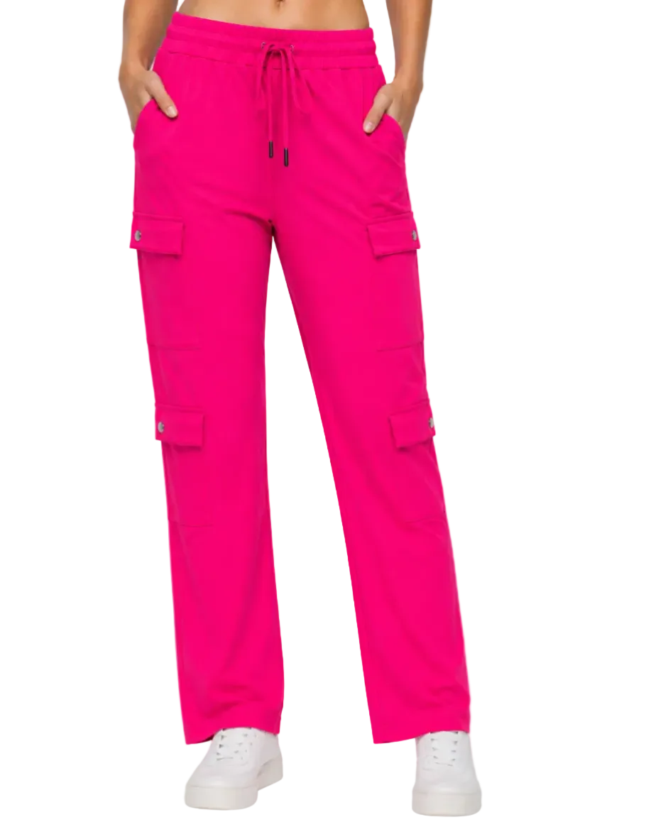 Bright pink cargo pants worn by a person on a white background
